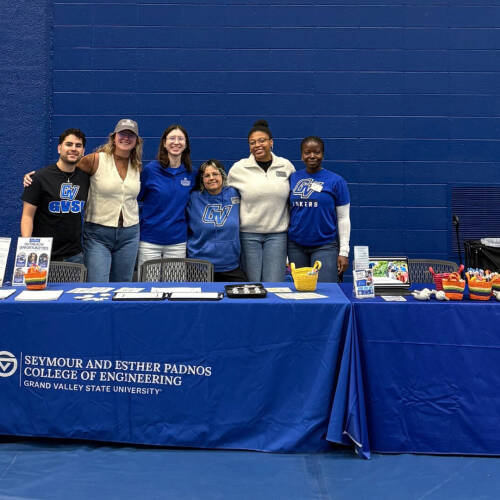 A group of GVSU staff and students representing the college of computing at an outreach event.